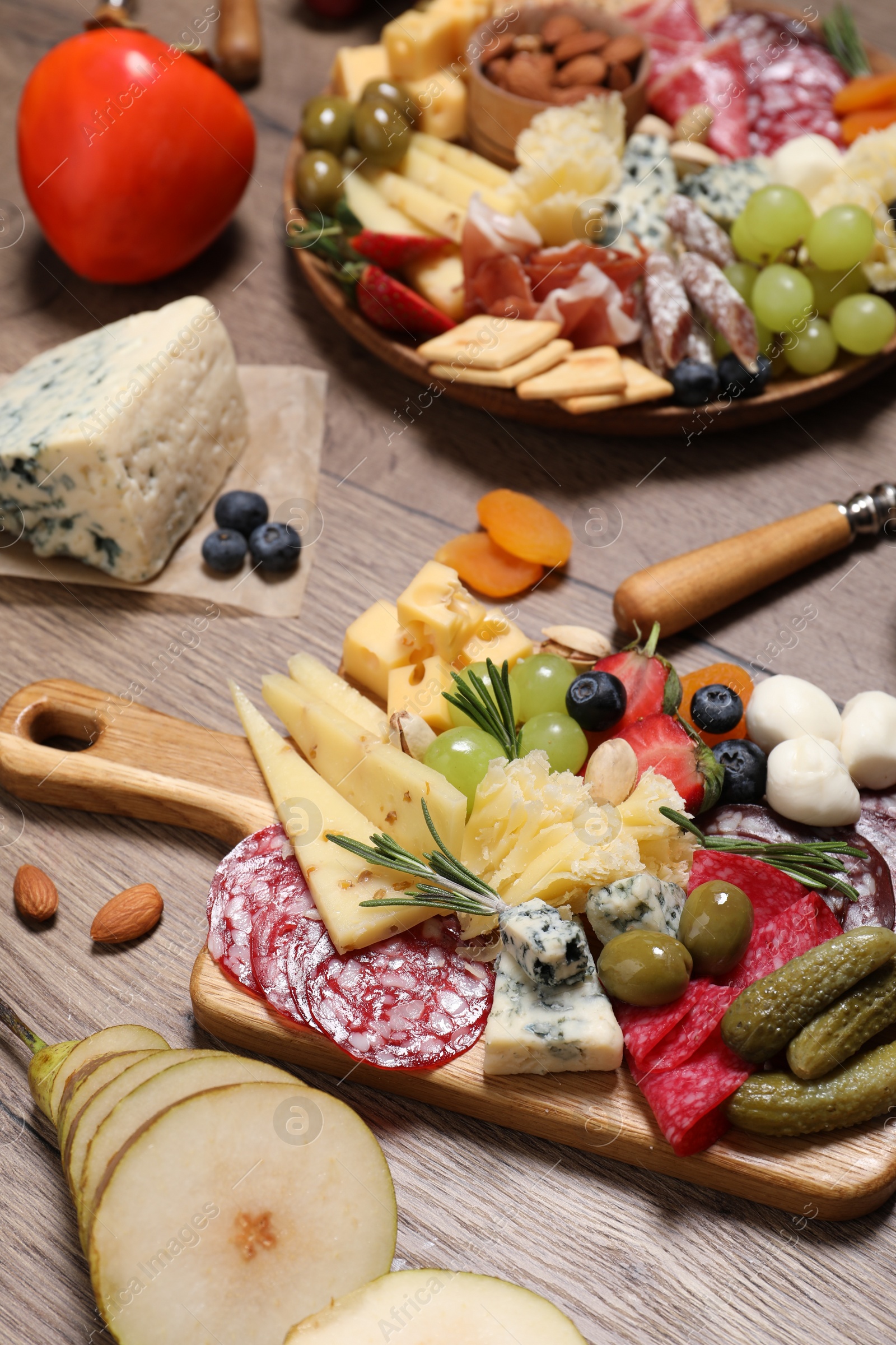 Photo of Many different appetizers served on wooden table