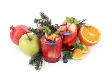 Aromatic Sangria drink in glasses, ingredients and Christmas decor on white background