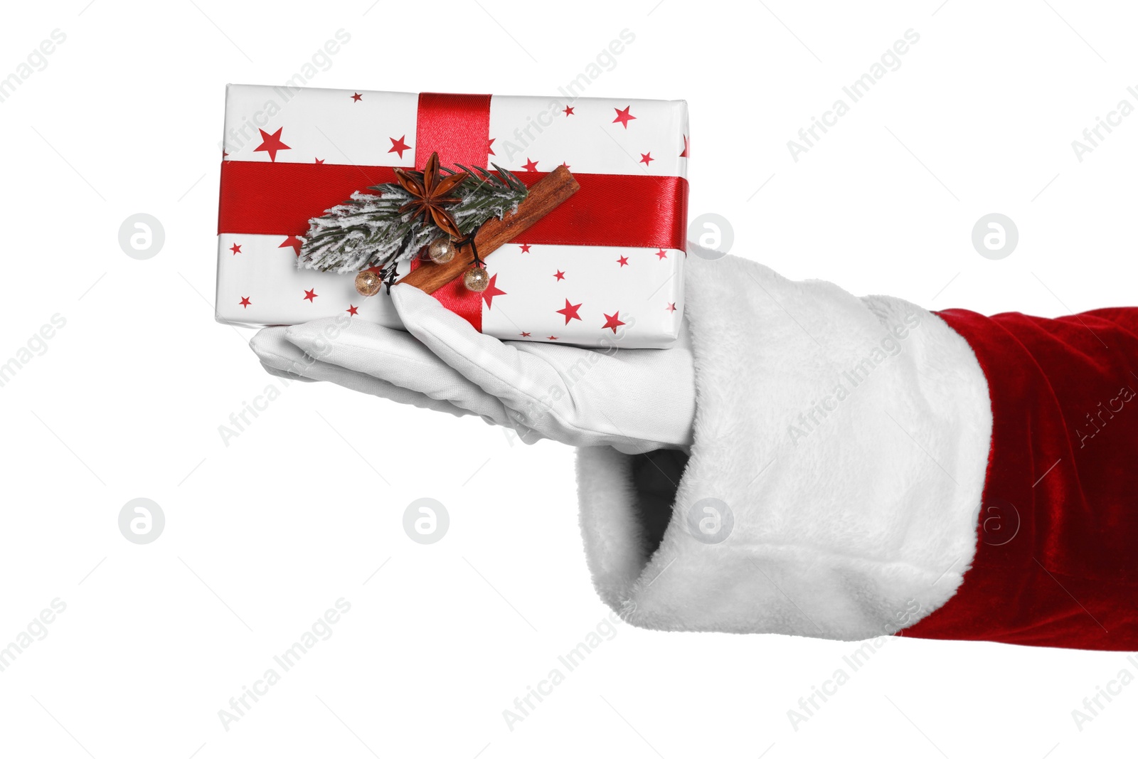 Photo of Merry Christmas. Santa Claus holding gift box decorated with fir and spices on white background, closeup