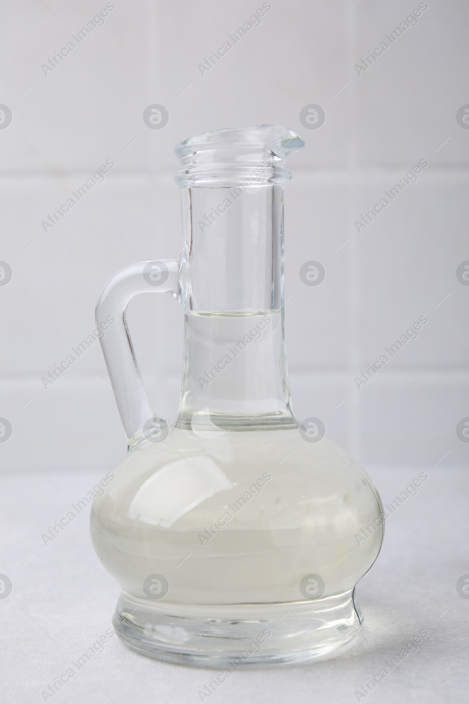 Photo of Vinegar in glass jug on light table