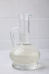 Vinegar in glass jug on light table