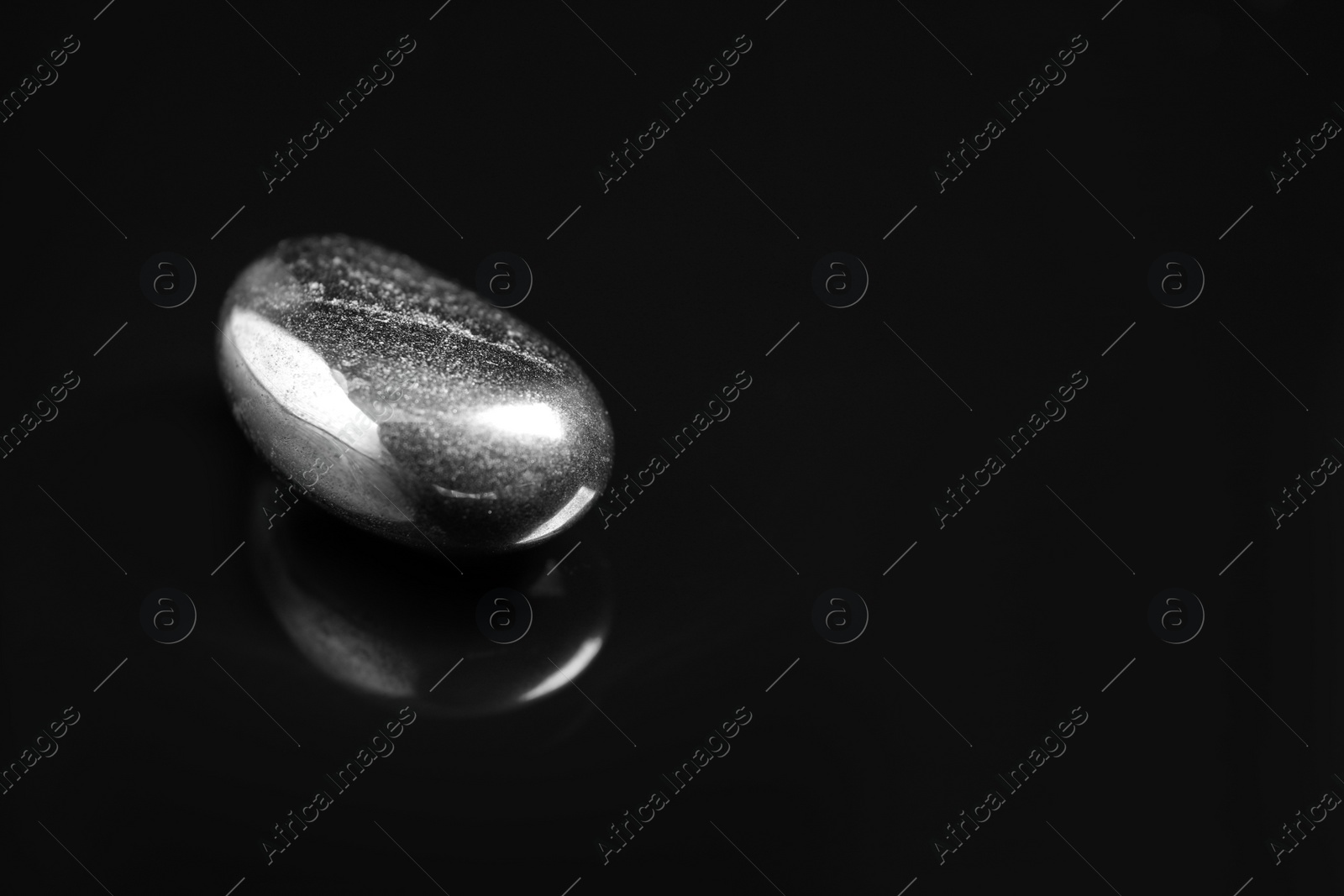 Photo of Beautiful hematite gemstone on black background. Space for text