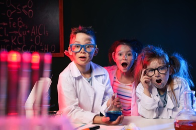 Children doing chemical research in laboratory. Dangerous experiment