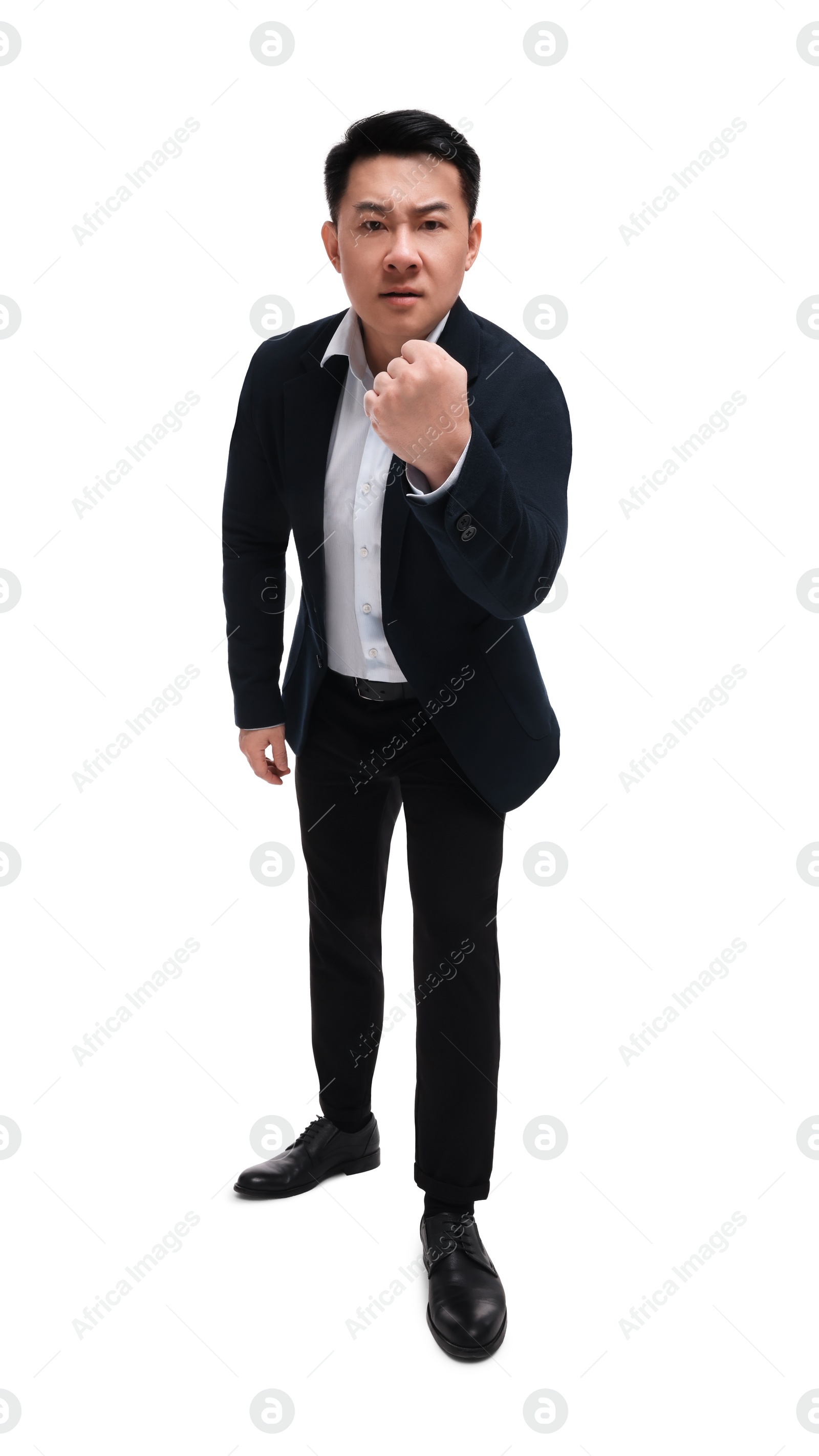 Photo of Angry businessman in suit posing on white background, low angle view