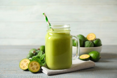 Fresh feijoa smoothie in mason jar on grey table