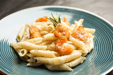 Photo of Delicious pasta with shrimps on plate, closeup