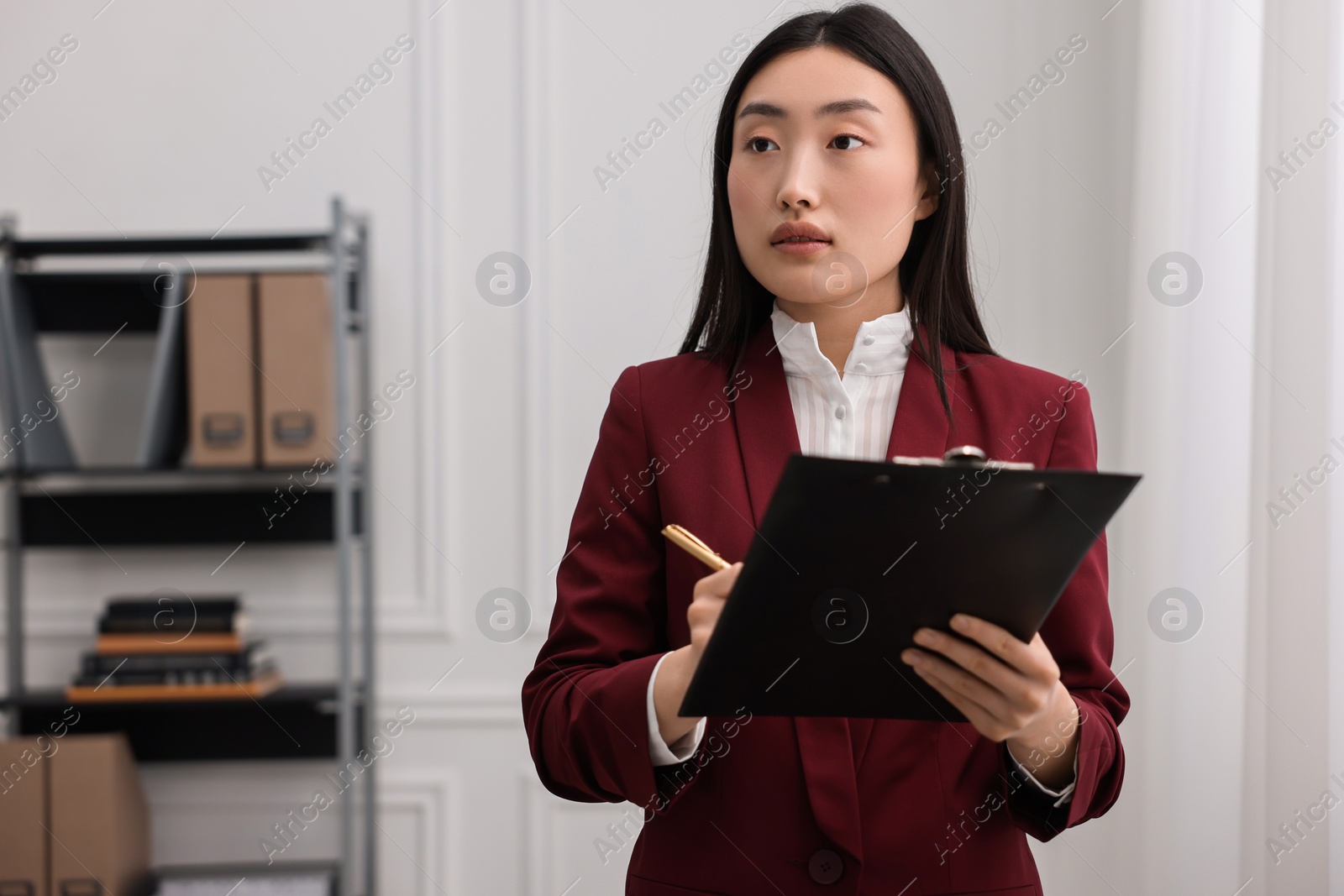 Photo of Portrait of notary with clipboard in office. Space for text