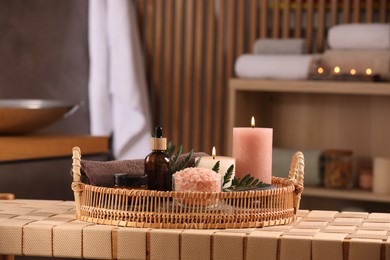 Beautiful composition with different spa products on wicker bench indoors