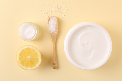 Flat lay composition with jars of cream on beige background. Body care product