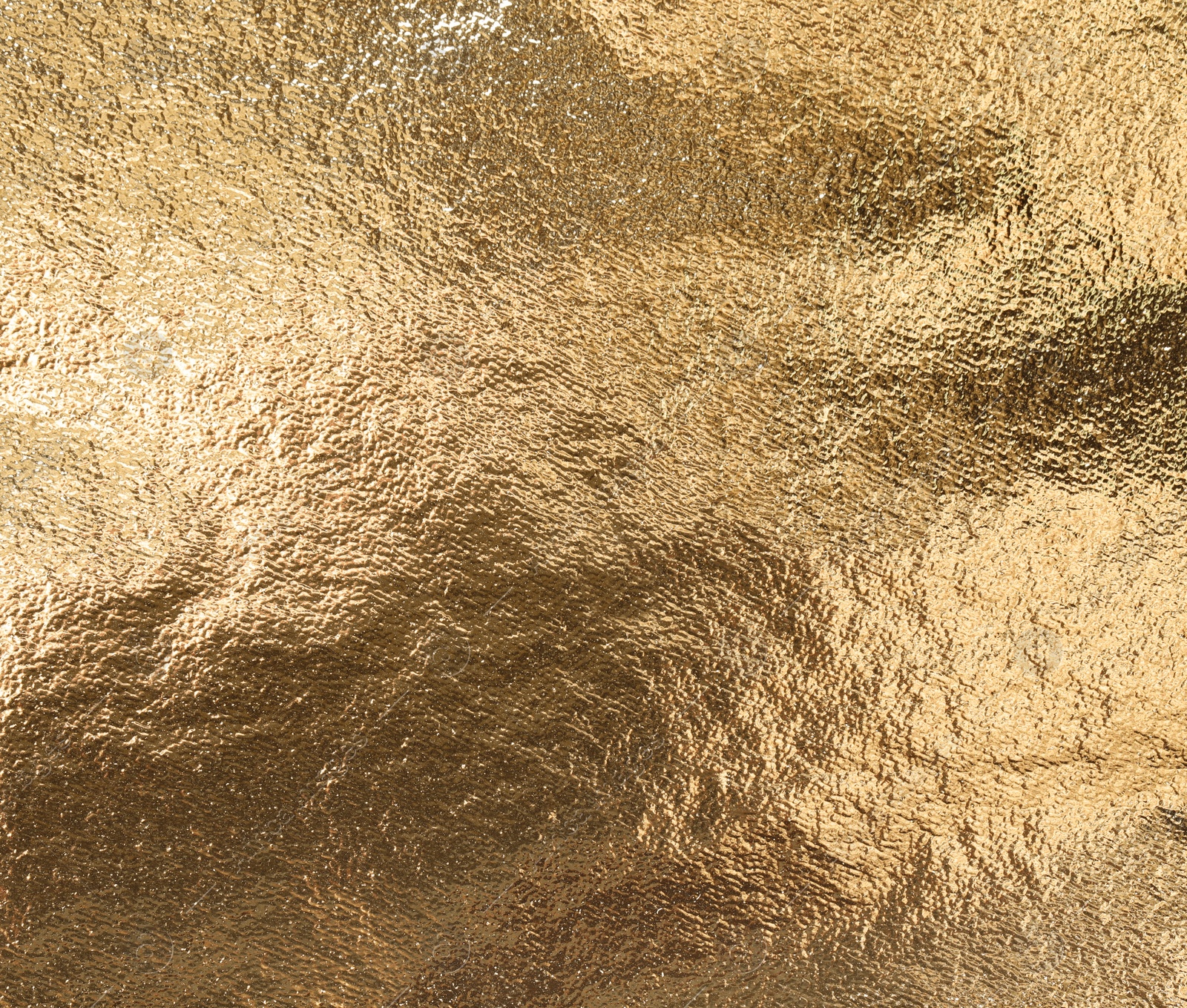 Photo of Textured golden foil as background, top view