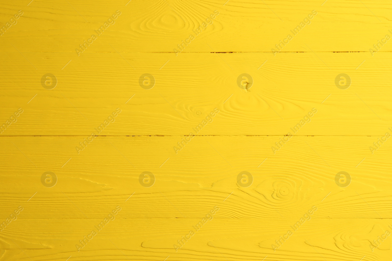 Photo of Texture of yellow wooden surface as background, closeup