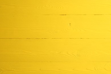 Photo of Texture of yellow wooden surface as background, closeup