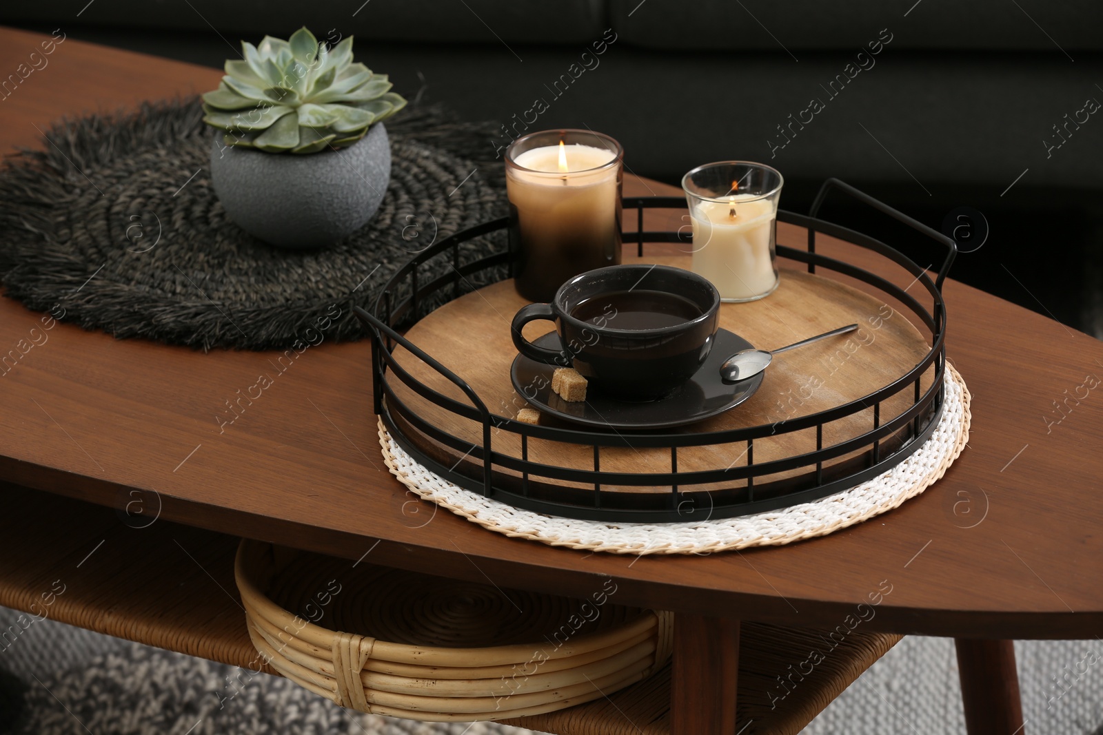 Photo of Freshly brewed coffee and decorative elements on wooden table in room