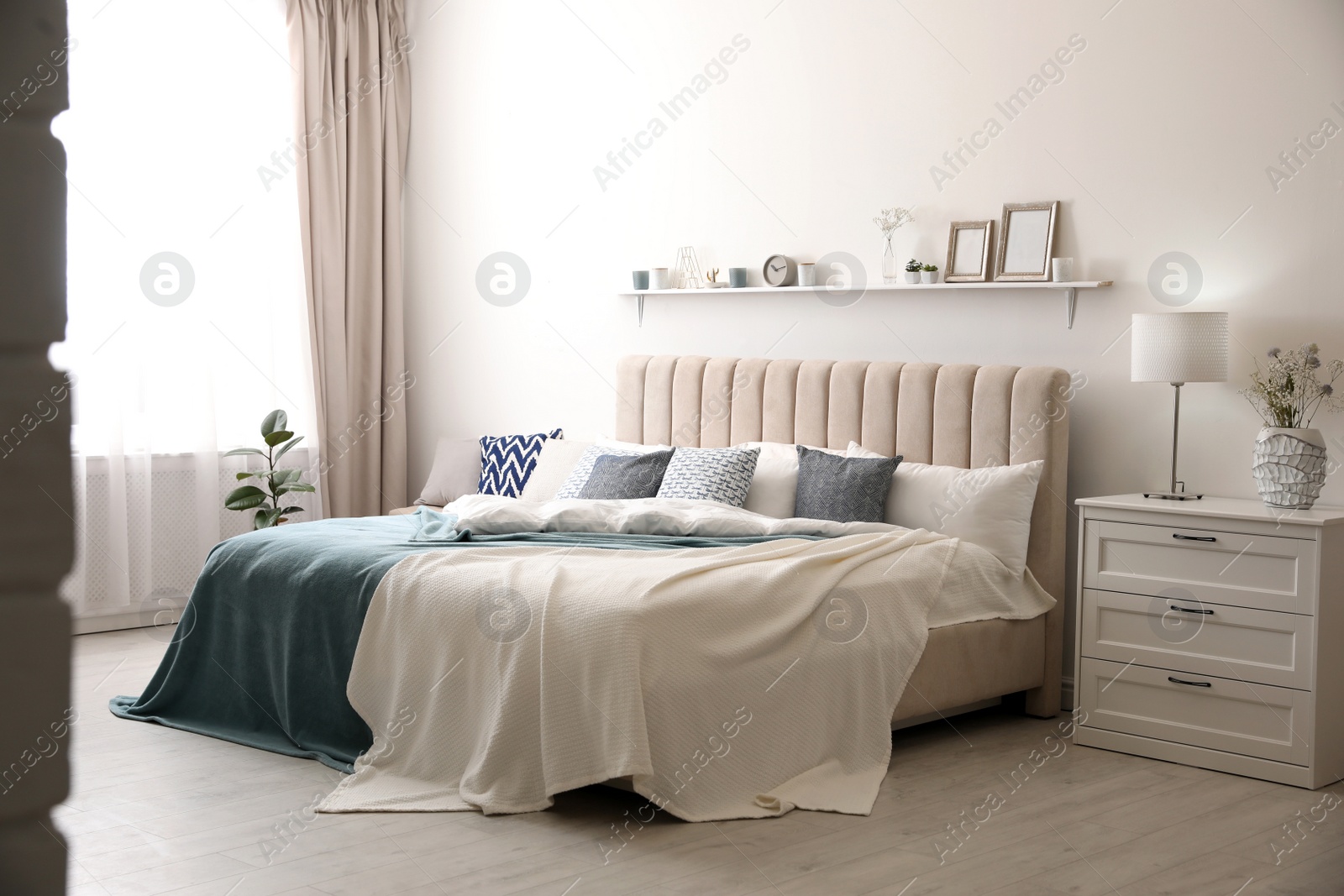 Photo of Comfortable bed with pillows in room. Stylish interior design