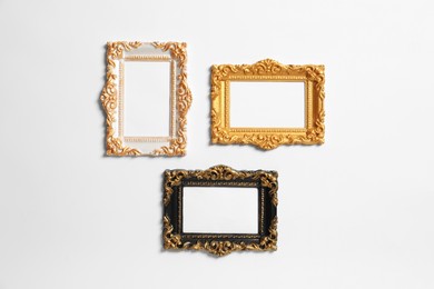 Photo of Empty vintage frames hanging on white wall
