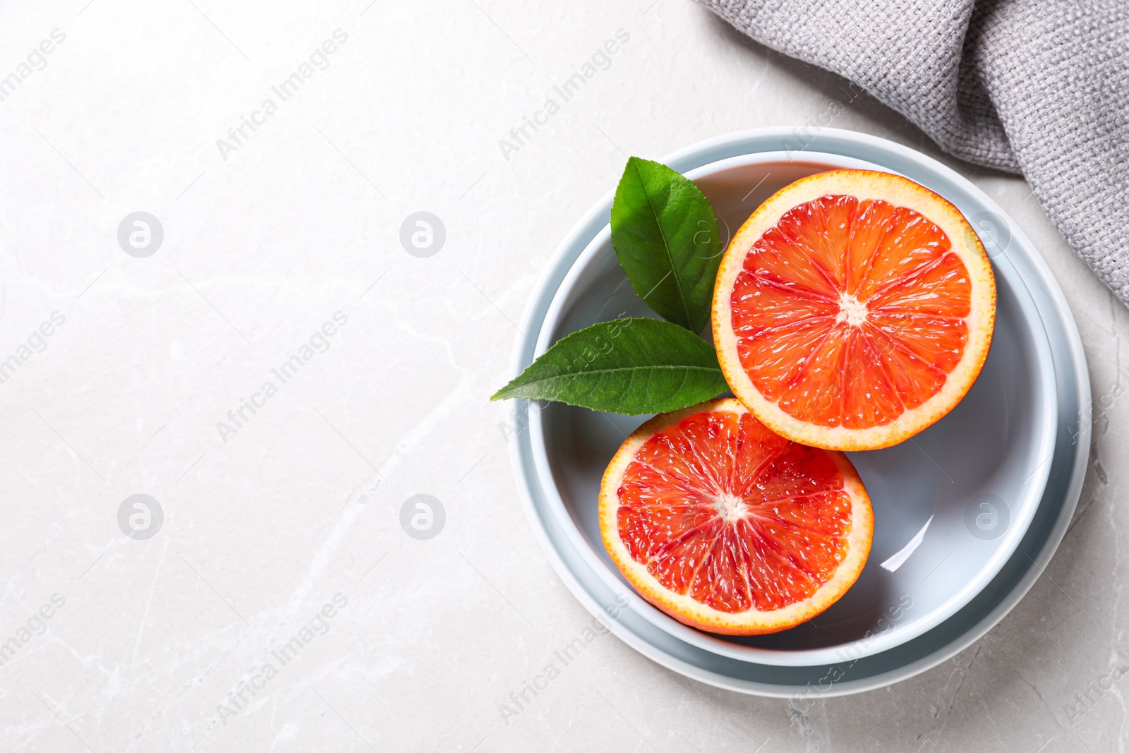 Photo of Slices of fresh ripe red orange on light table, flat lay. Space for text