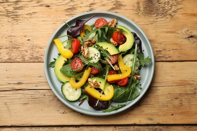 Balanced diet and vegetarian foods. Plate with different delicious products on wooden table, top view