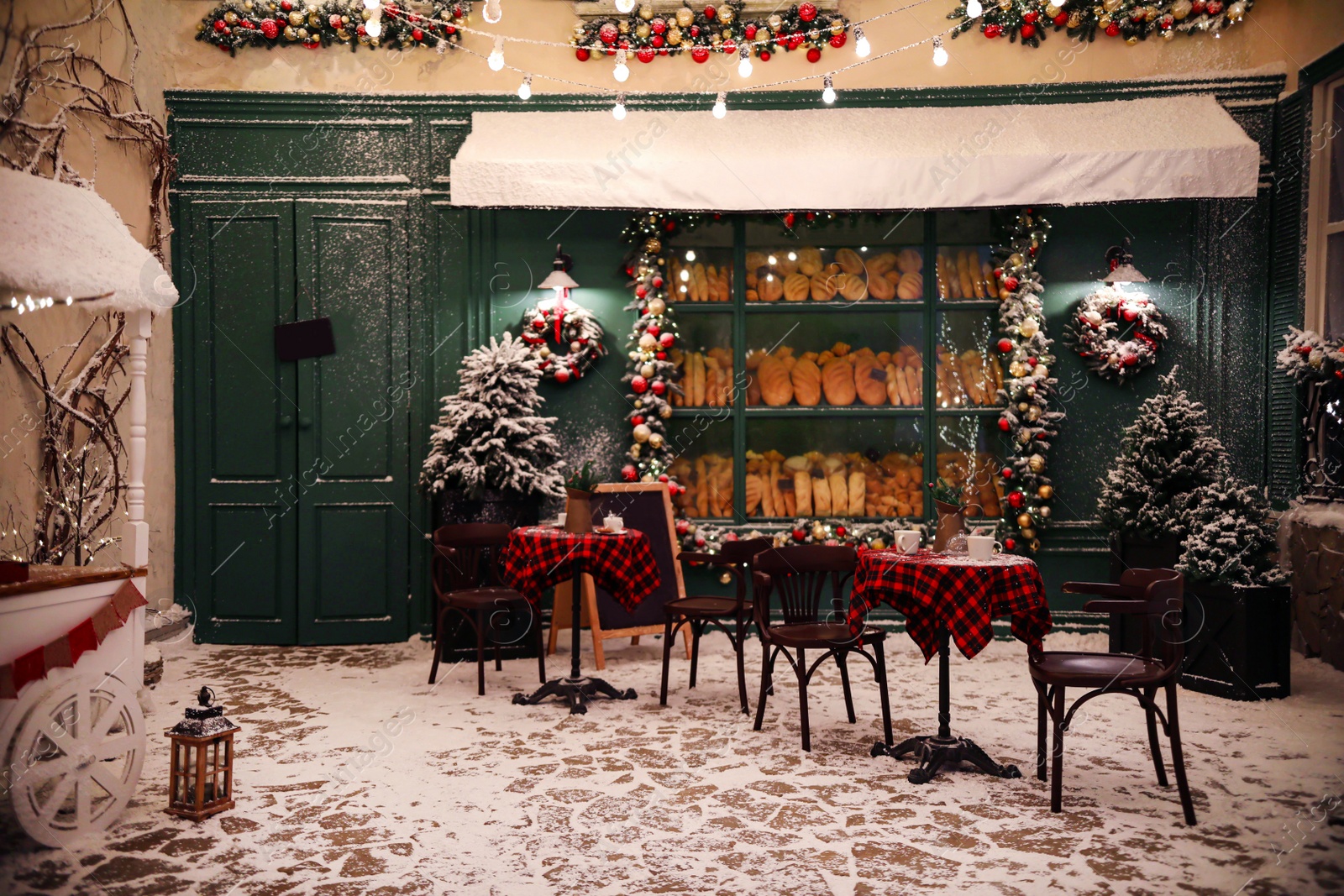 Photo of Beautiful outdoor cafe with festive decoration. Christmas celebration