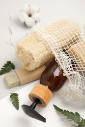 Photo of Mesh bag with eco friendly personal care products on color background, closeup