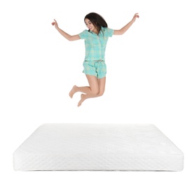 Photo of Young woman jumping on mattress against white background