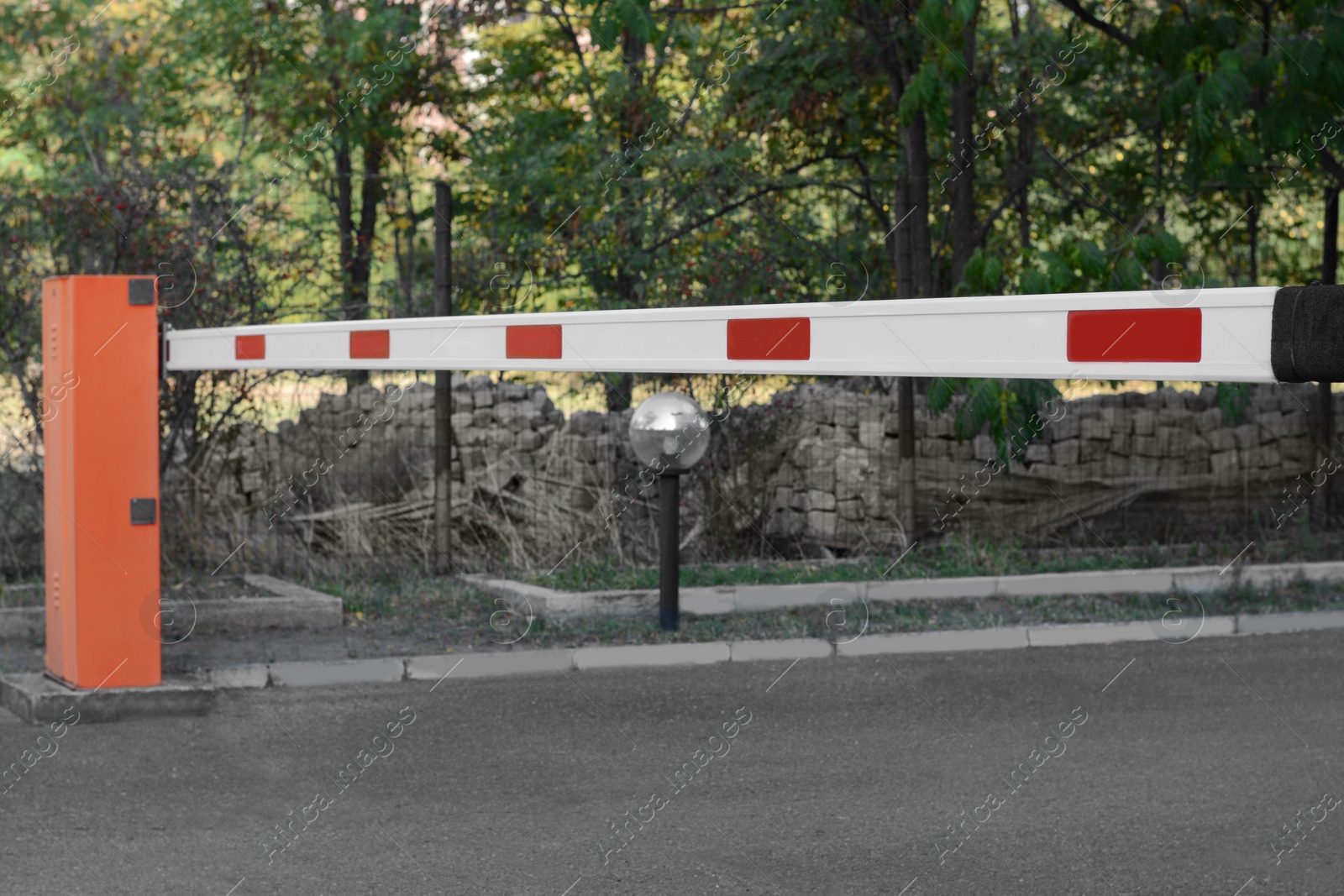 Photo of Closed boom barrier outdoors on sunny day