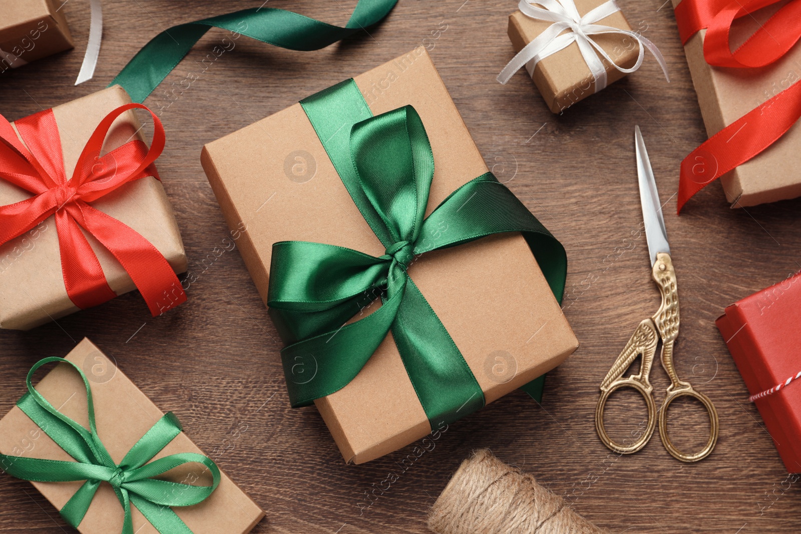 Photo of Flat lay composition with beautiful Christmas gift boxes on wooden table
