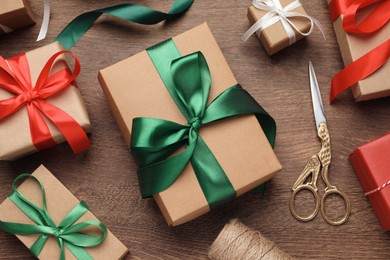 Flat lay composition with beautiful Christmas gift boxes on wooden table