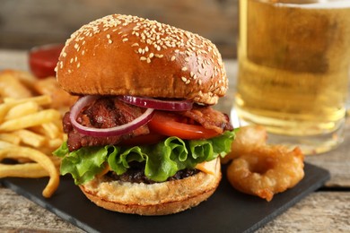 Photo of Tasty burger with French fries served on wooden table, closeup. Fast food