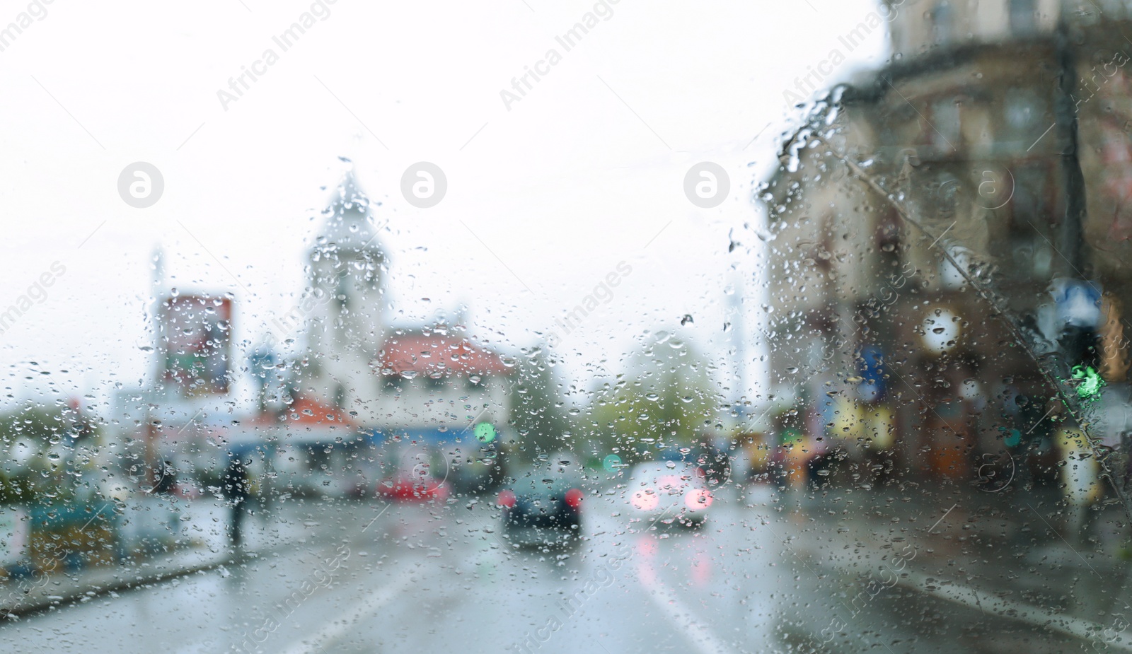 Photo of Blurred view of road through wet car window. Rainy weather