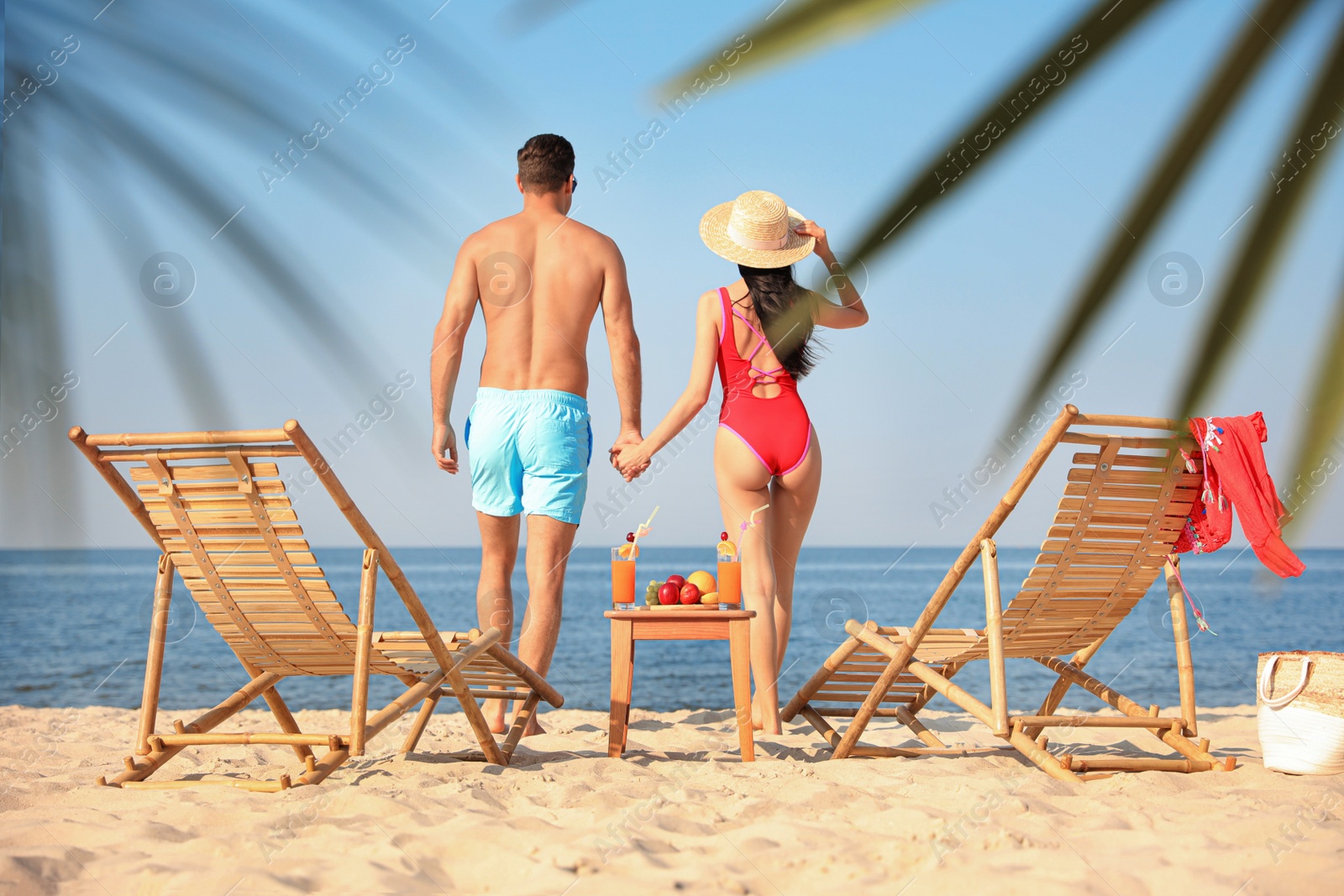 Photo of Couple resting on sunny beach at resort