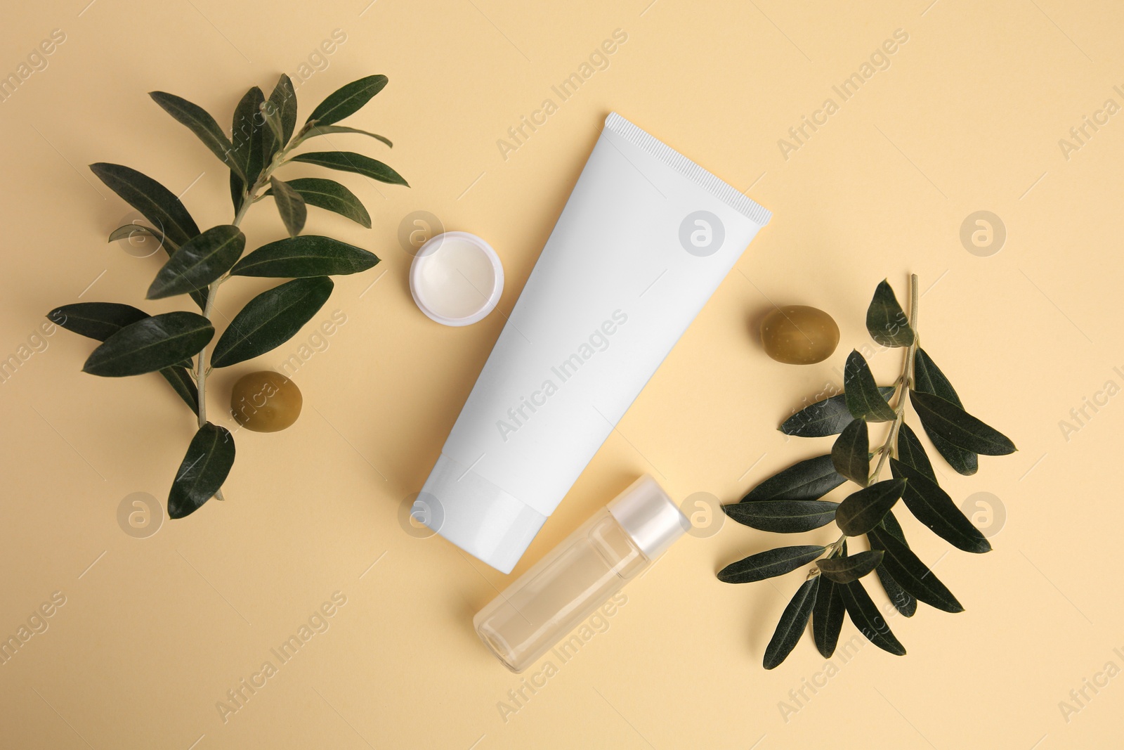 Photo of Different cosmetic products and ingredient on beige background, flat lay