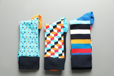 Photo of Flat lay composition with different colorful socks on gray background