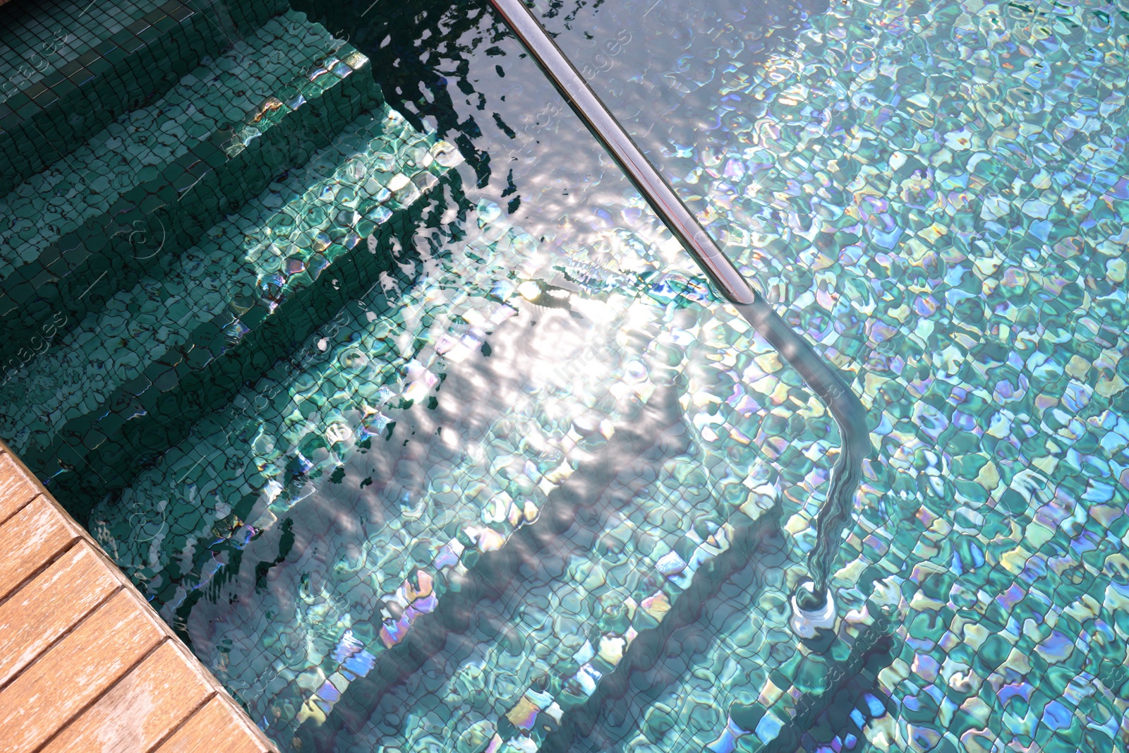 Photo of Outdoor swimming pool with steps and rail at resort