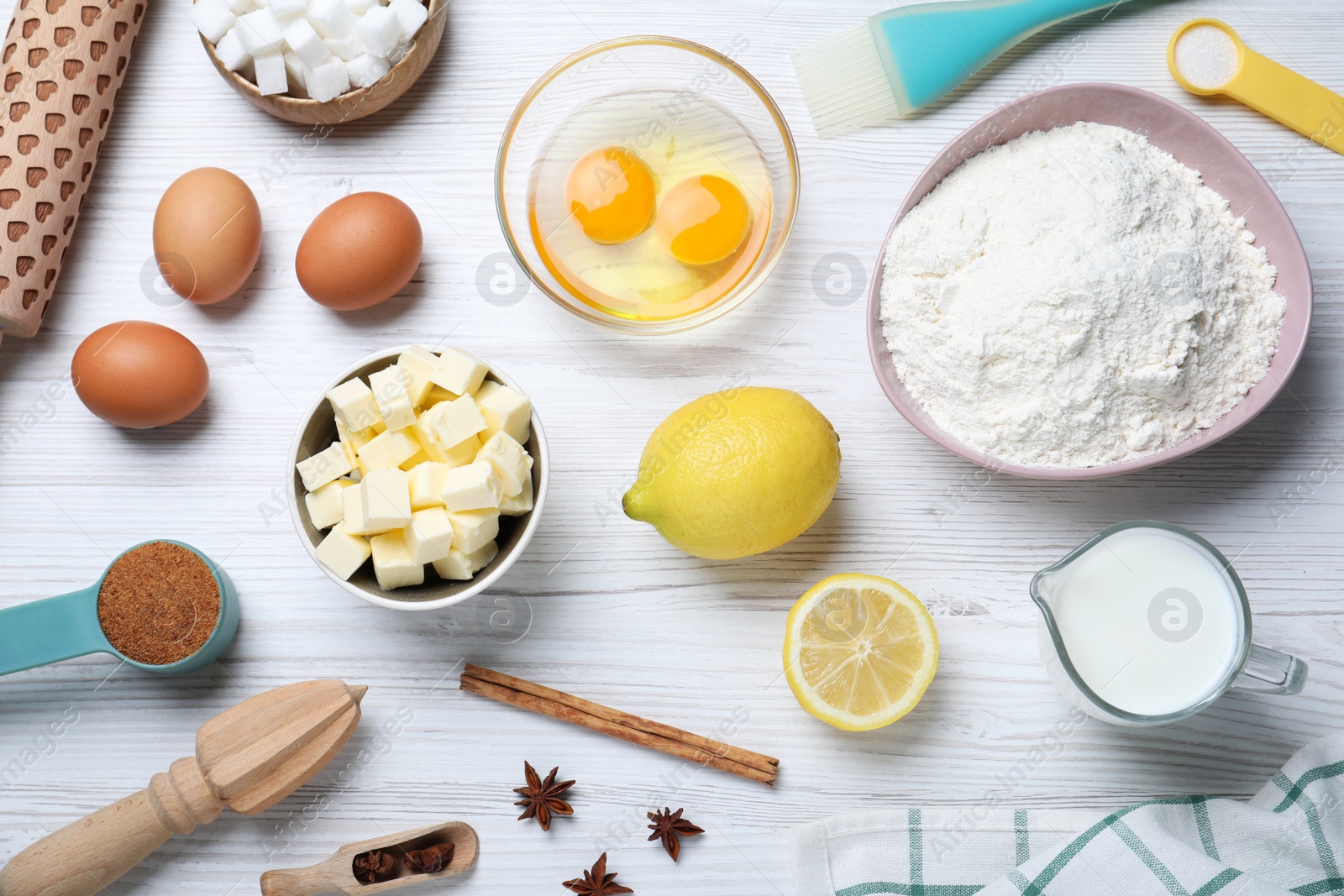 Photo of Cooking utensils and ingredients on white wooden table, flat lay