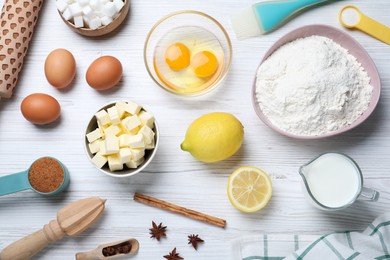 Photo of Cooking utensils and ingredients on white wooden table, flat lay