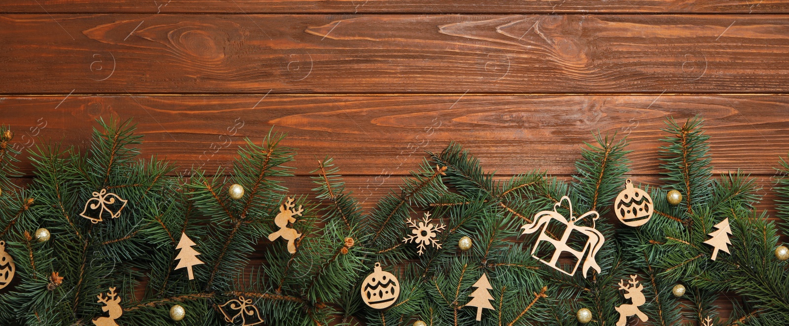 Photo of Christmas decorations on wooden background, top view. Space for text