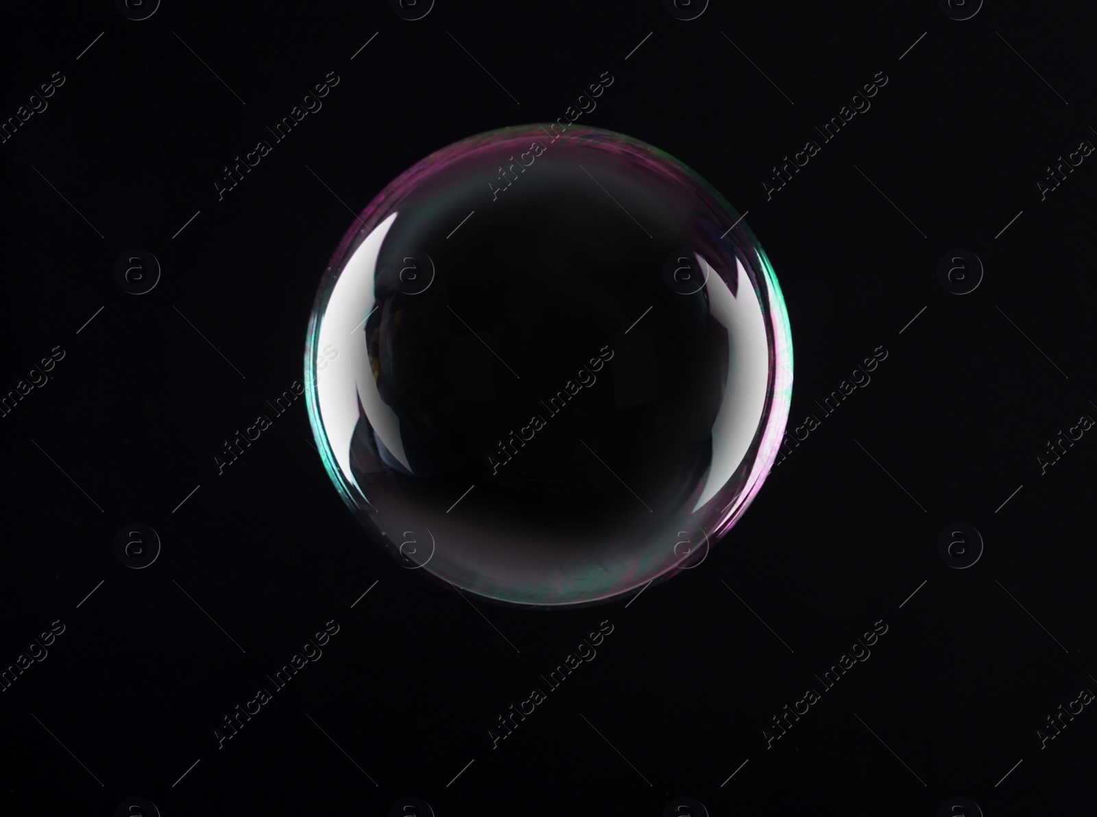 Photo of Beautiful translucent soap bubble on dark background. Space for text