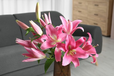 Photo of Beautiful pink lily flowers in vase at home, closeup