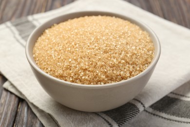 Brown sugar in bowl on table, closeup