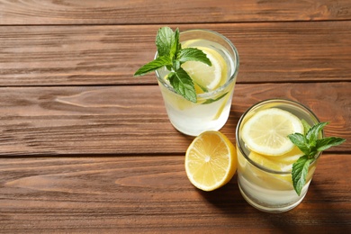 Natural lemonade with mint in glasses on wooden table