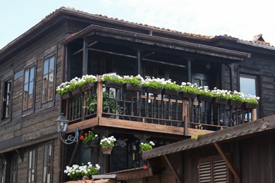 Exterior of beautiful residential building with balcony and flowers