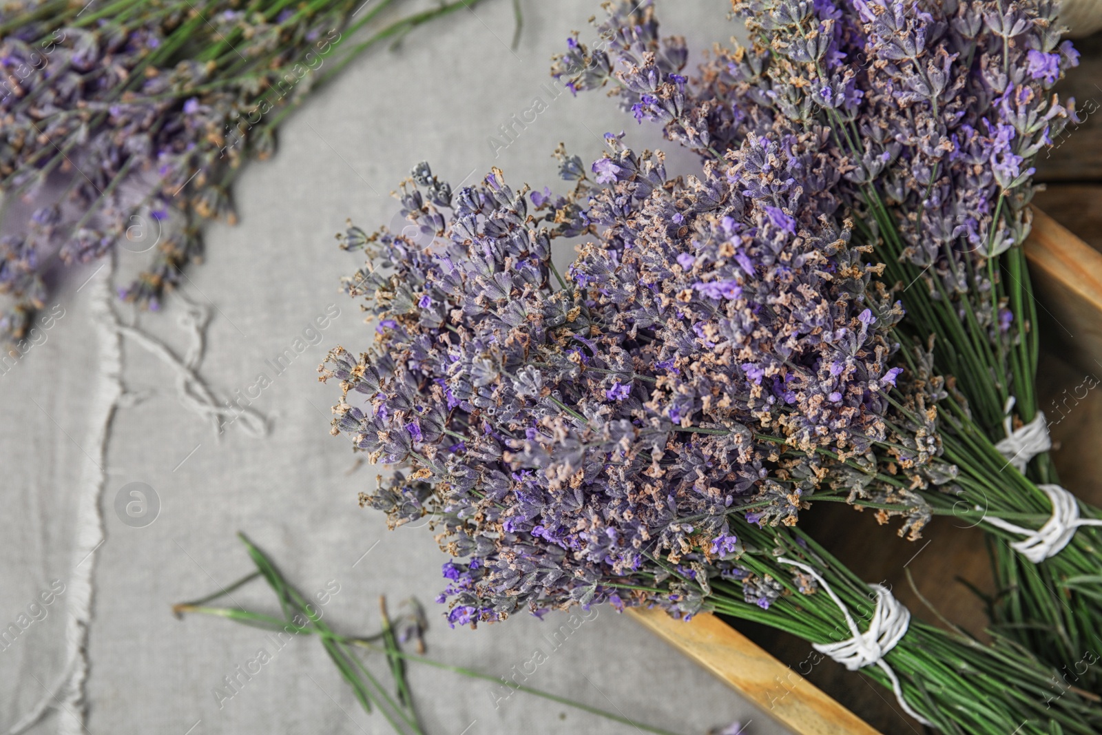 Photo of Wooden box with lavender flowers on table, top view