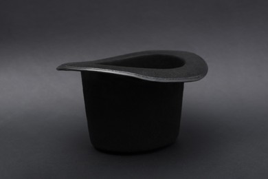 Photo of One magician top hat on dark grey background
