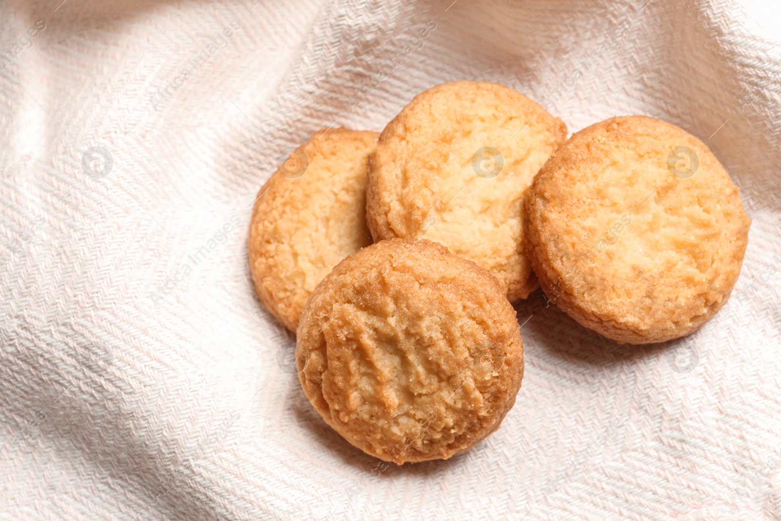 Photo of Tasty Danish butter cookies on color napkin, top view. Space for text