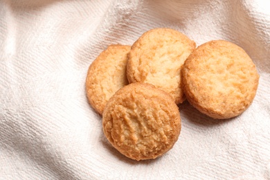 Photo of Tasty Danish butter cookies on color napkin, top view. Space for text