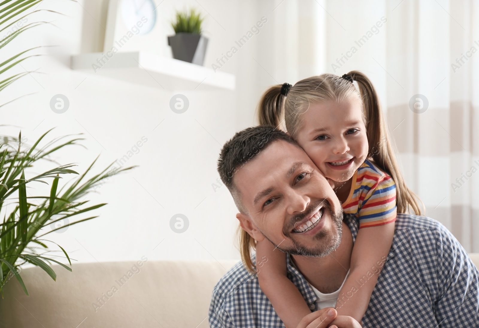 Photo of Dad and daughter spending time together at home. Happy Father's Day