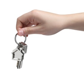 Woman holding keys with keychain in shape of house isolated on white, closeup