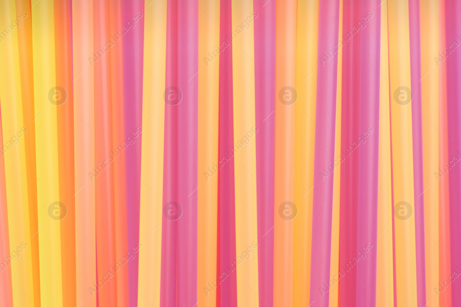 Photo of Heap of colorful plastic straws for drinks as background, closeup