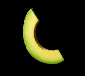Slice of fresh avocado on black background