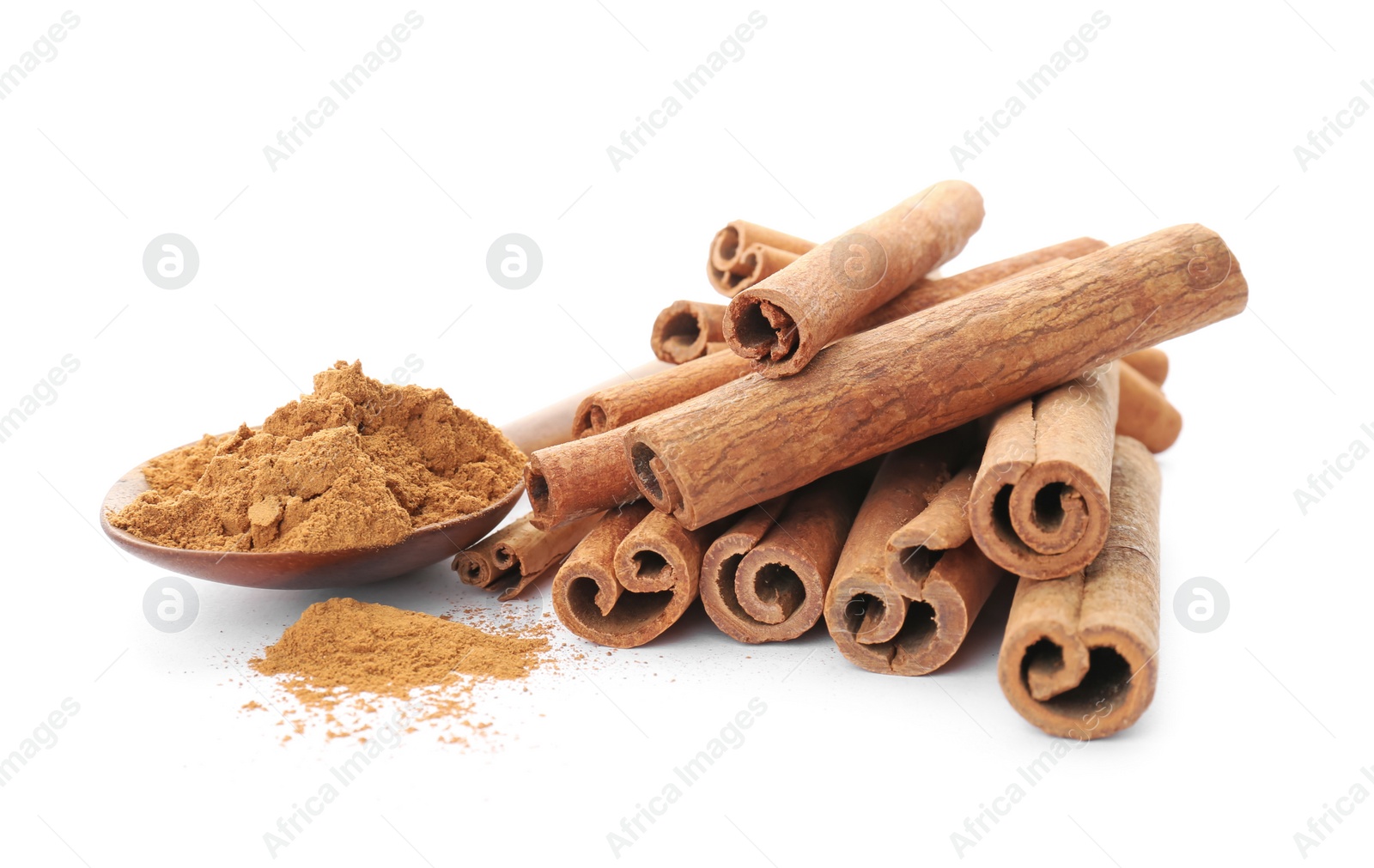 Photo of Aromatic cinnamon sticks and spoon with powder on white background